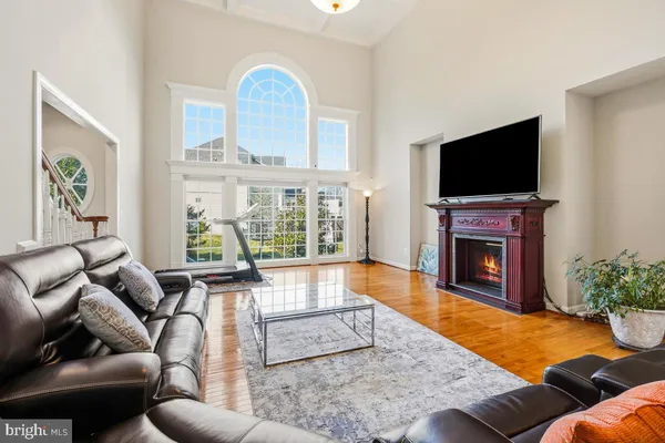 a open kitchen with stainless steel appliances granite countertop a stove top oven a sink dishwasher a dining table and chairs with wooden floor