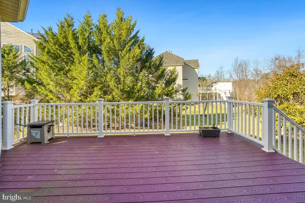 a spacious bathroom with a double vanity sink a mirror a bathtub and next to a window