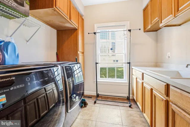 a bathroom with a granite countertop sink toilet and mirror