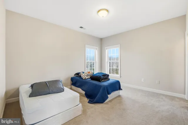a dining room with furniture and a floor to ceiling window