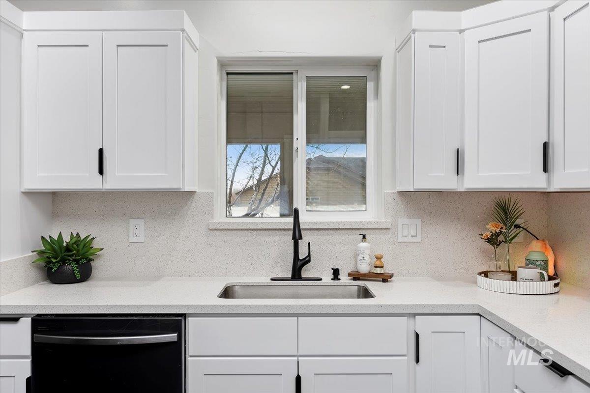 1189 Trail Crest Road Twin Falls, ID 83301 - Photo 12 of 44 Kitchen featuring white cabinets, light stone countertops, and dishwasher