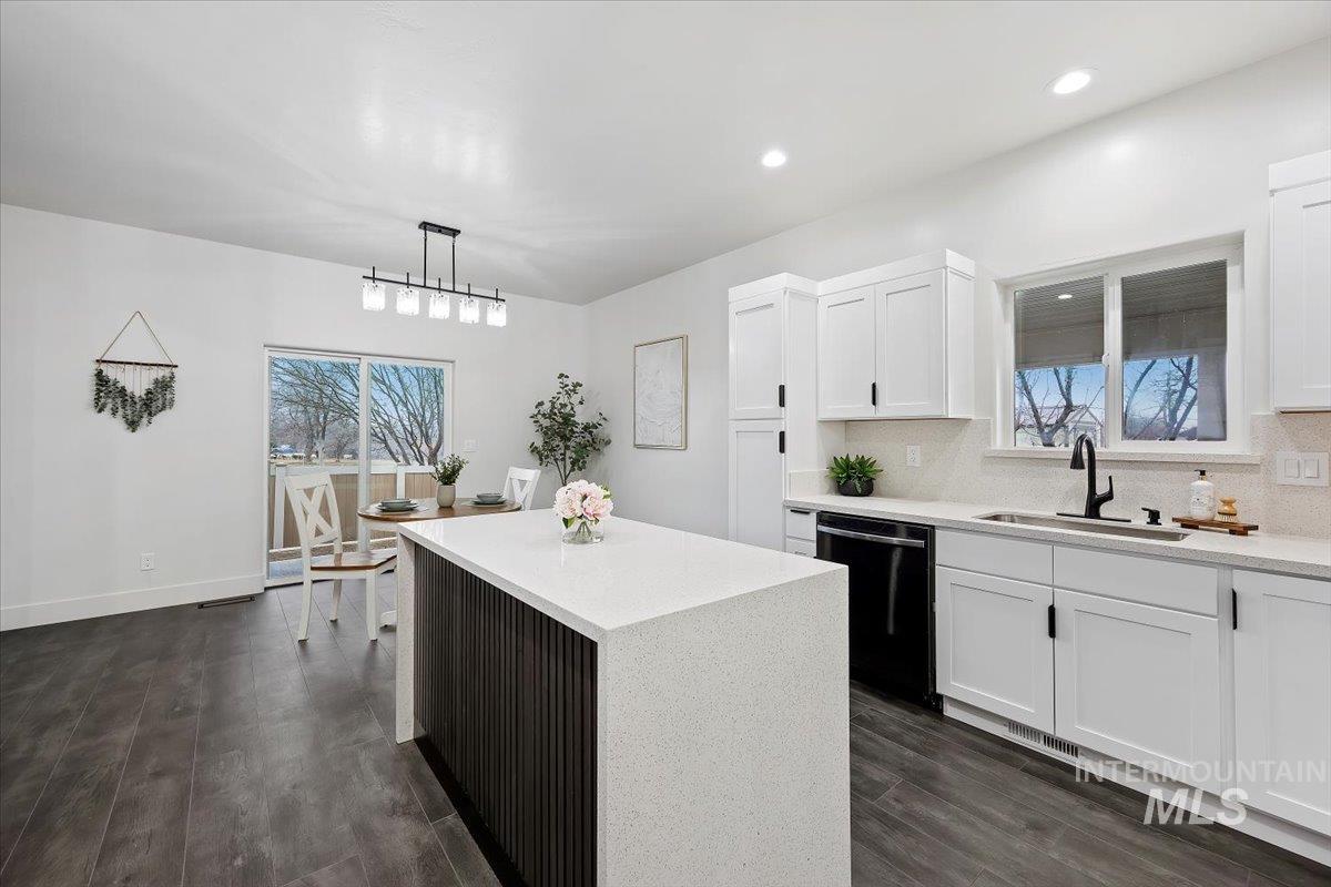 1189 Trail Crest Road Twin Falls, ID 83301 - Photo 14 of 44 Kitchen with pendant lighting, black dishwasher, white cabinetry, light stone counters, and recessed lighting