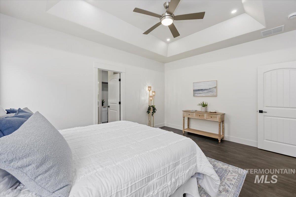 1189 Trail Crest Road Twin Falls, ID 83301 - Photo 19 of 44 Bedroom with a tray ceiling, recessed lighting, dark wood-style floors, and ceiling fan