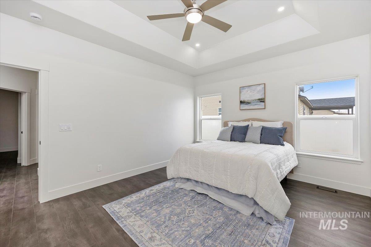1189 Trail Crest Road Twin Falls, ID 83301 - Photo 20 of 44 Bedroom with wood finished floors, a tray ceiling, ceiling fan, and recessed lighting