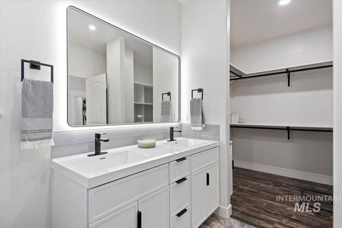 1189 Trail Crest Road Twin Falls, ID 83301 - Photo 23 of 44 Full bath with double vanity, recessed lighting, a spacious closet, and dark wood-type flooring