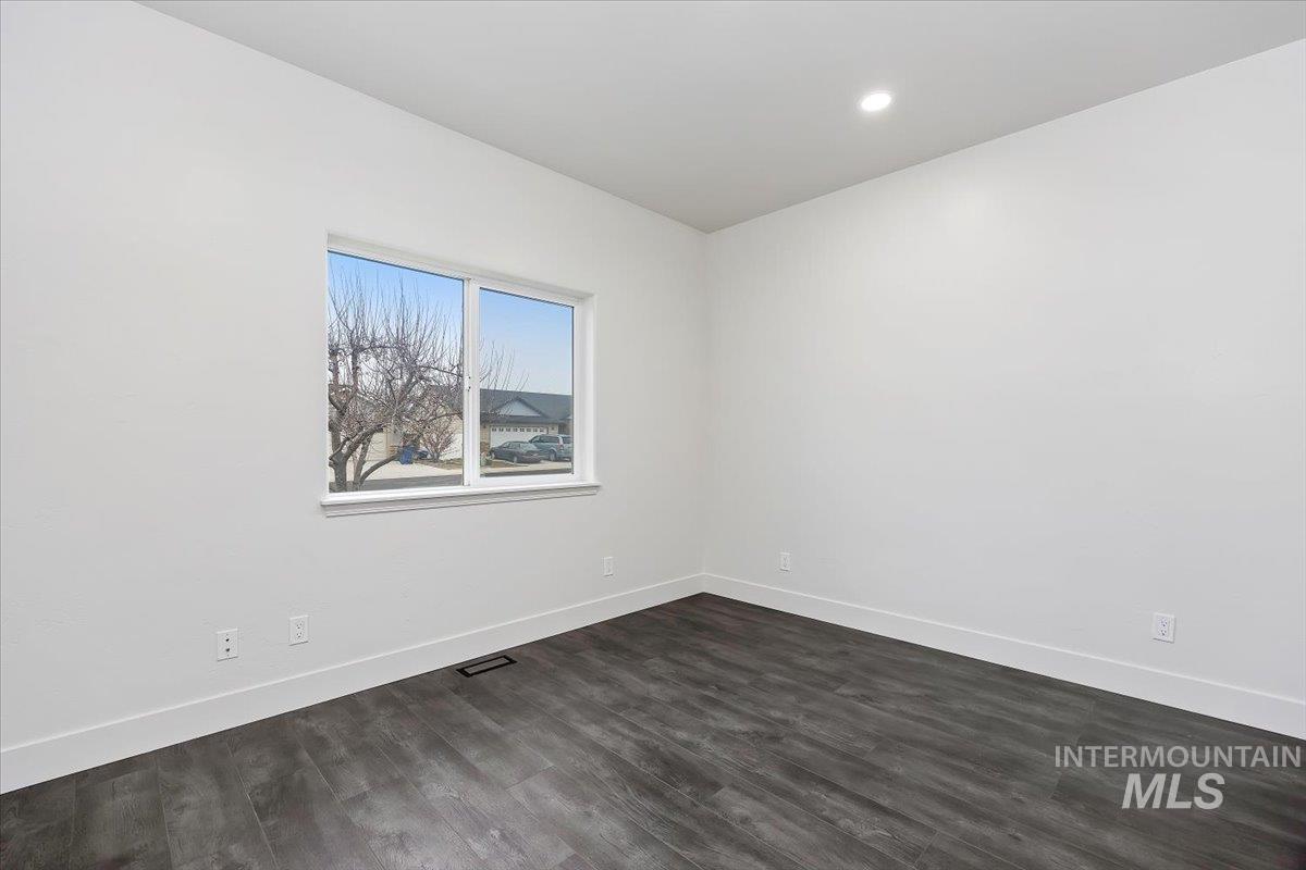 1189 Trail Crest Road Twin Falls, ID 83301 - Photo 25 of 44 Spare room featuring baseboards and dark wood-style floors