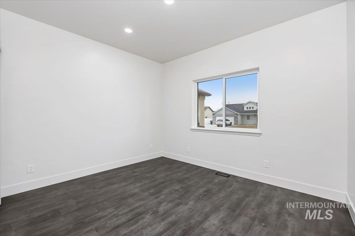 1189 Trail Crest Road Twin Falls, ID 83301 - Photo 27 of 44 Empty room with dark wood-style floors and recessed lighting