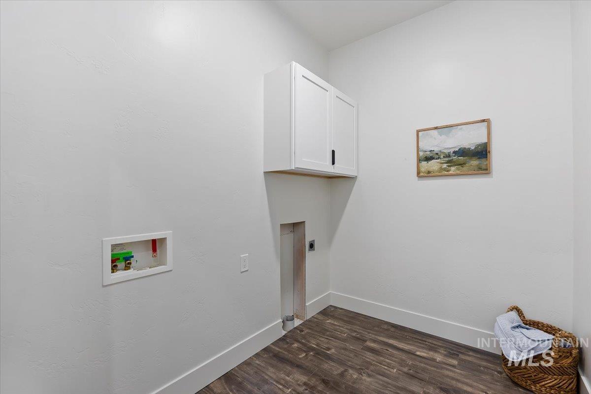 1189 Trail Crest Road Twin Falls, ID 83301 - Photo 28 of 44 Laundry area featuring cabinet space, dark wood-style floors, washer hookup, and hookup for an electric dryer