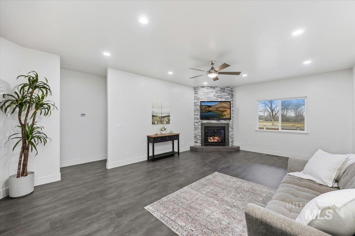 1189 Trail Crest Road Twin Falls, ID 83301 - Photo 5 of 44 Living room featuring a ceiling fan, dark wood finished floors, a large fireplace, and recessed lighting