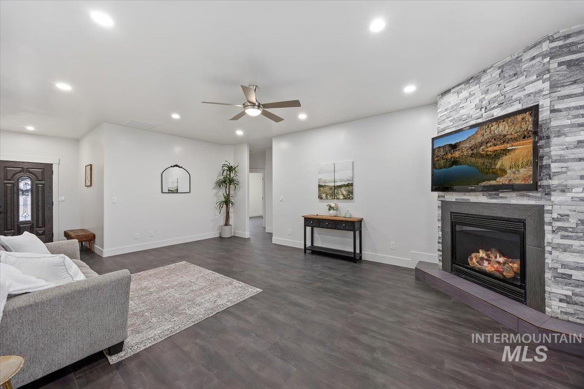 1189 Trail Crest Road Twin Falls, ID 83301 - Photo 8 of 44 Living room with a fireplace, dark wood finished floors, a ceiling fan, and recessed lighting