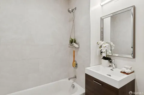 a bathroom with a sink a mirror and a bathtub