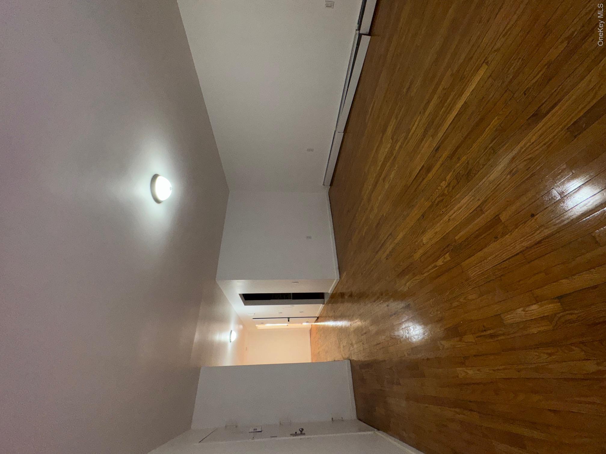 631 Coster Street Bronx, NY 10474 - Photo 16 of 17 a view of an empty room with wooden floor
