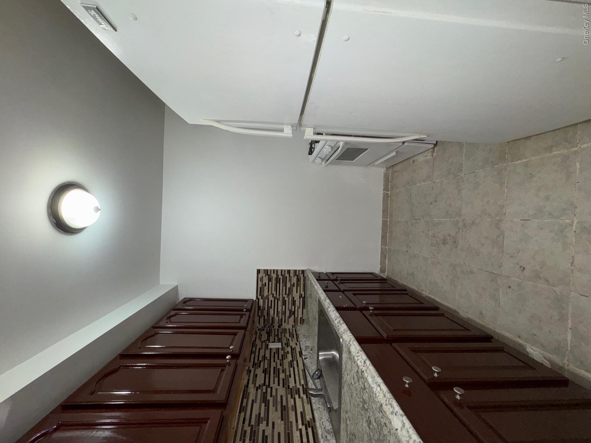 631 Coster Street Bronx, NY 10474 - Photo 6 of 17 a kitchen with stainless steel appliances a sink stove and cabinets