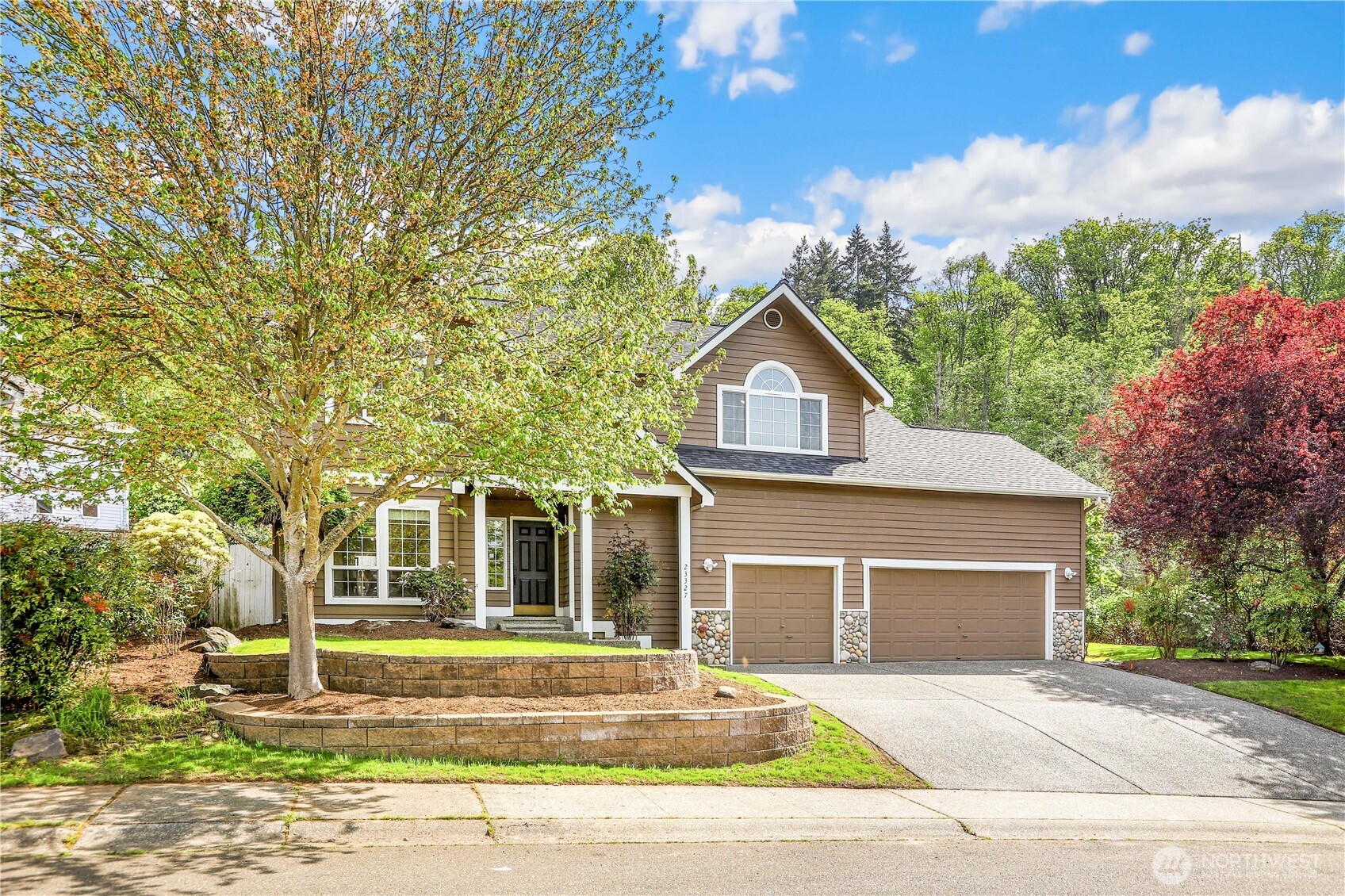23327 8th Place West Bothell, WA 98021 - Photo 2 of 40 a front view of a house with a garden and yard
