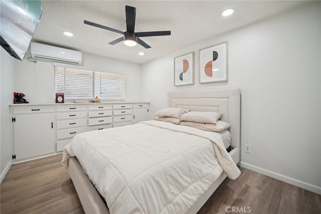 47078 Kings Canyon Road Lancaster, CA 93536 - Photo 17 of 63 a bedroom with a large bed and a ceiling fan