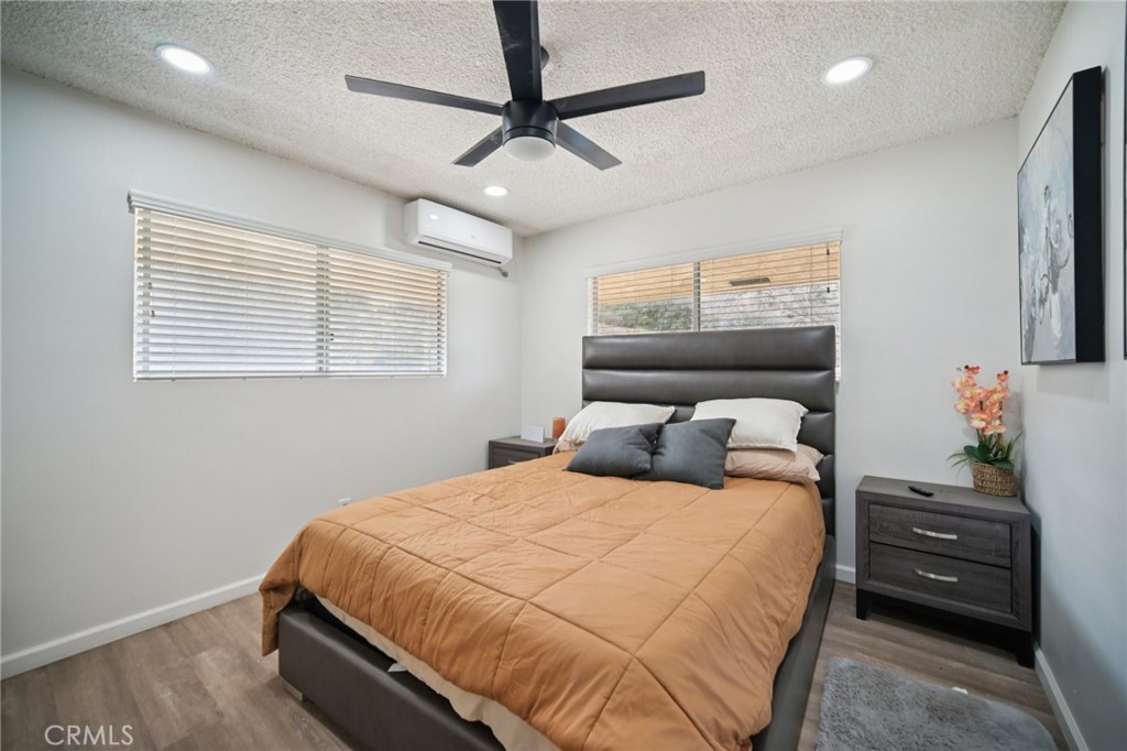 47078 Kings Canyon Road Lancaster, CA 93536 - Photo 21 of 63 a bedroom with a bed and a chandelier