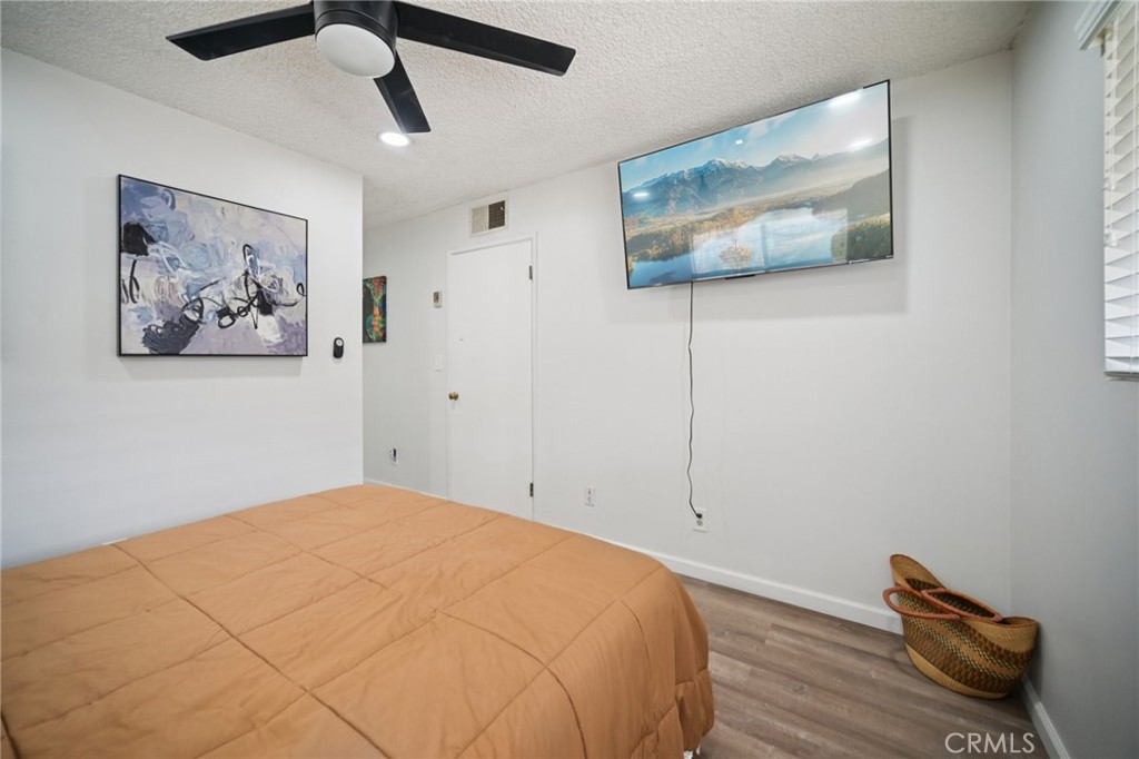 47078 Kings Canyon Road Lancaster, CA 93536 - Photo 22 of 63 a bedroom with a bed and a painting on the wall