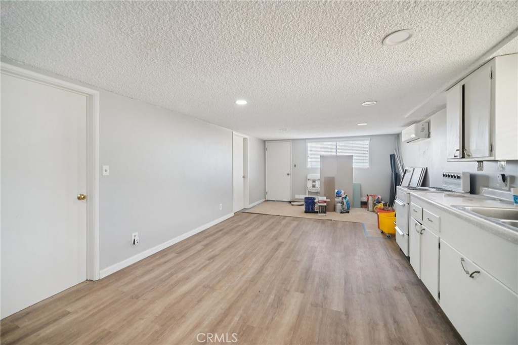 47078 Kings Canyon Road Lancaster, CA 93536 - Photo 29 of 63 a view of a big room with wooden floor and furniture