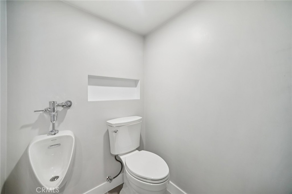 47078 Kings Canyon Road Lancaster, CA 93536 - Photo 36 of 63 a white toilet sitting next to a bathroom sink