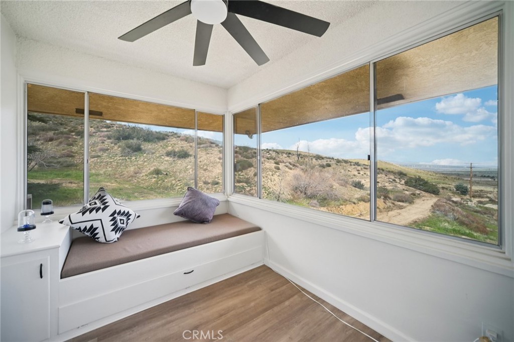 47078 Kings Canyon Road Lancaster, CA 93536 - Photo 40 of 63 a living room with furniture and a floor to ceiling window