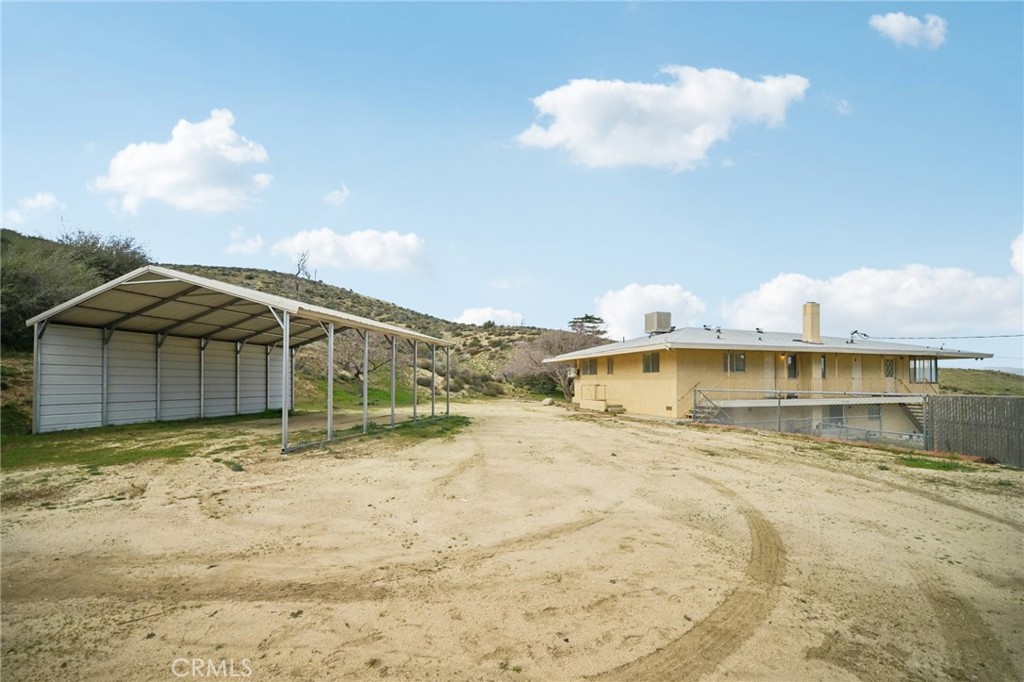 47078 Kings Canyon Road Lancaster, CA 93536 - Photo 44 of 63 a view of a house with a yard