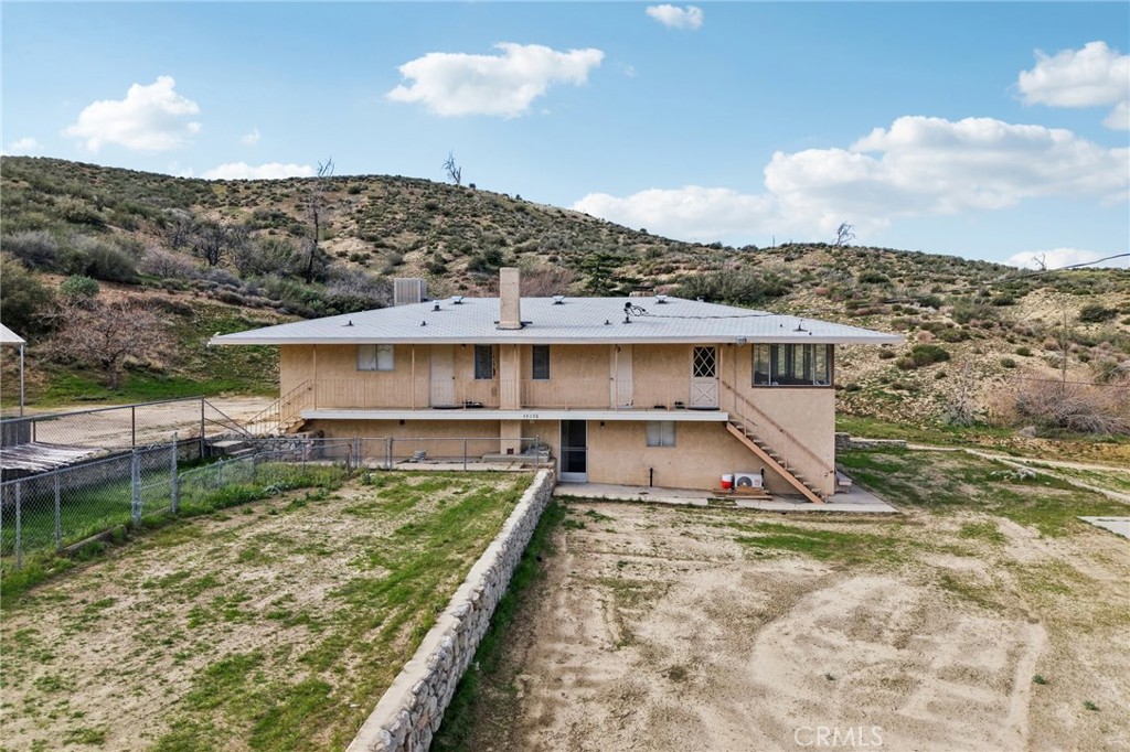 47078 Kings Canyon Road Lancaster, CA 93536 - Photo 46 of 63 a view of a house with a yard