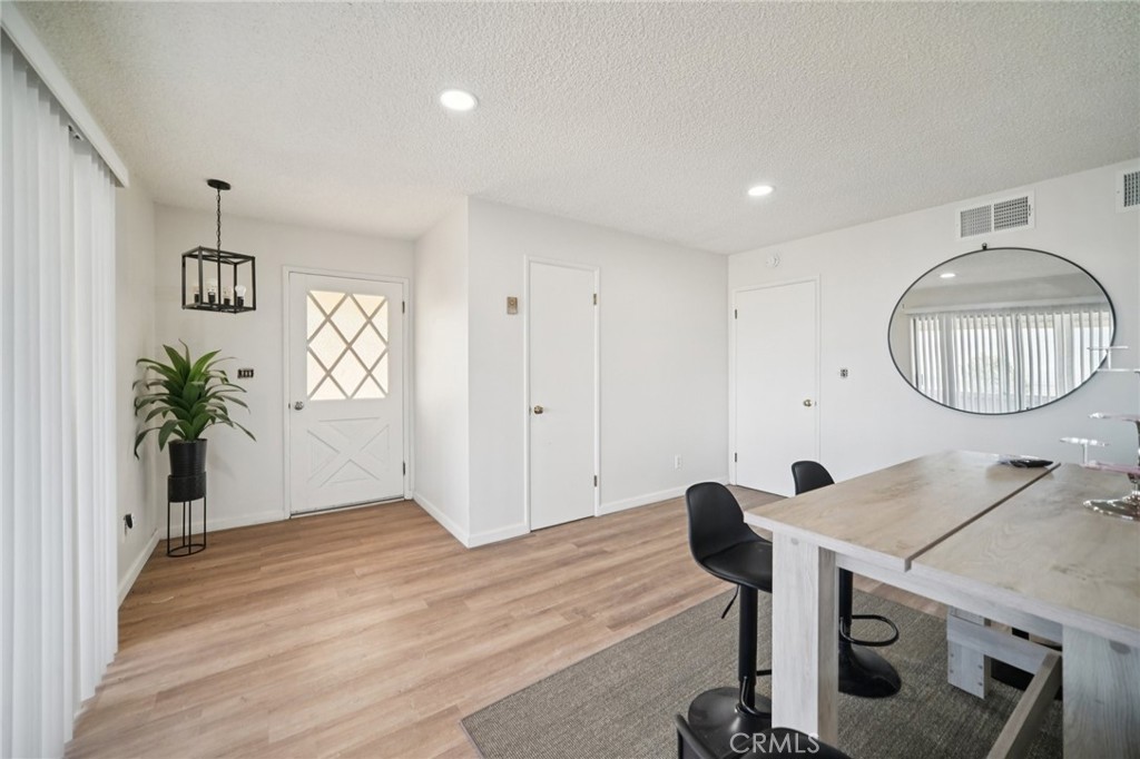47078 Kings Canyon Road Lancaster, CA 93536 - Photo 5 of 63 a view of entryway with livingroom and wooden floor