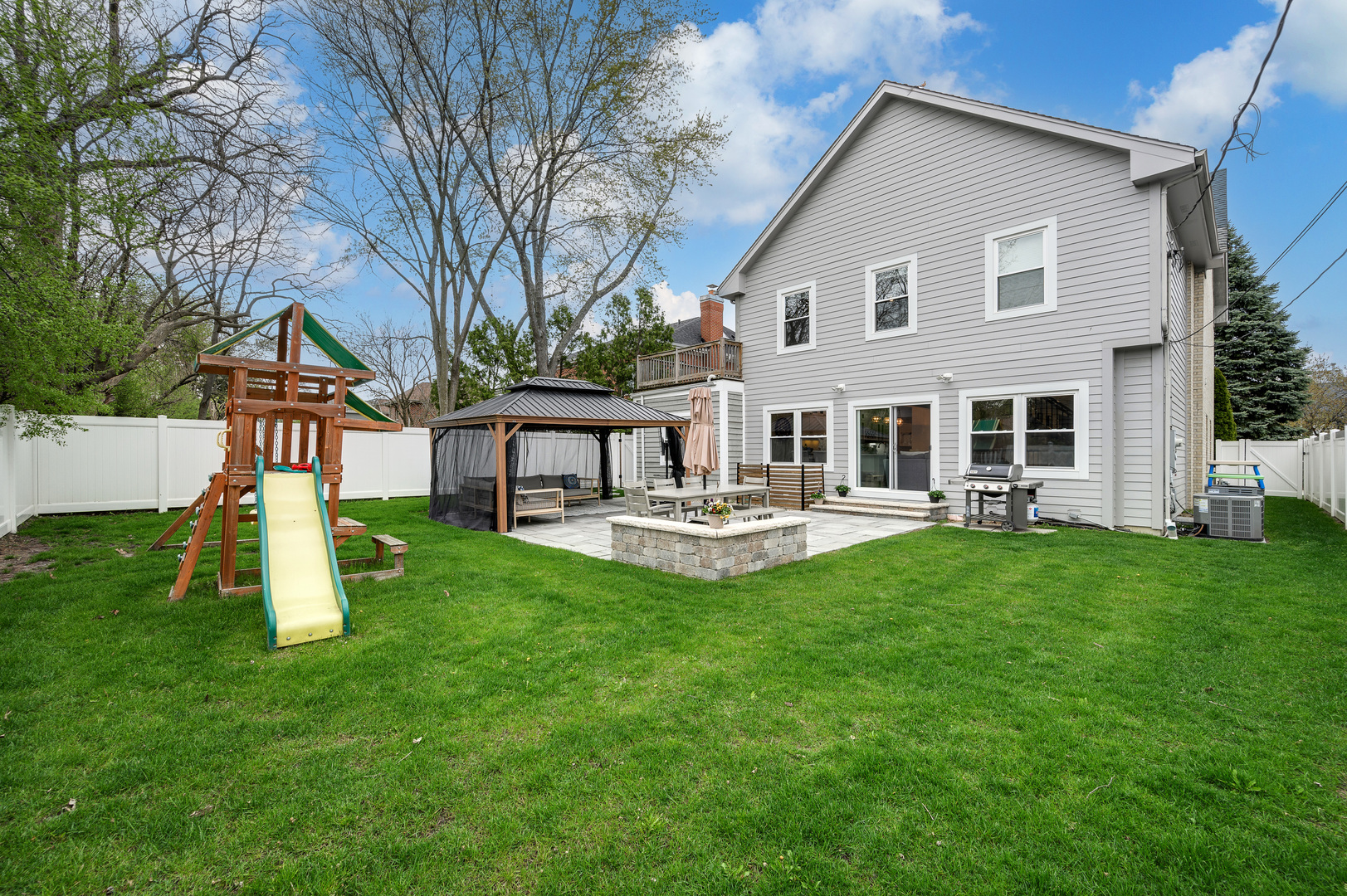 808 Rolling Pass Glenview, IL 60025 - Photo 28 of 33 a front view of a house with a yard table and chairs