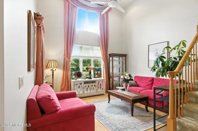 a living room with furniture plant and a window