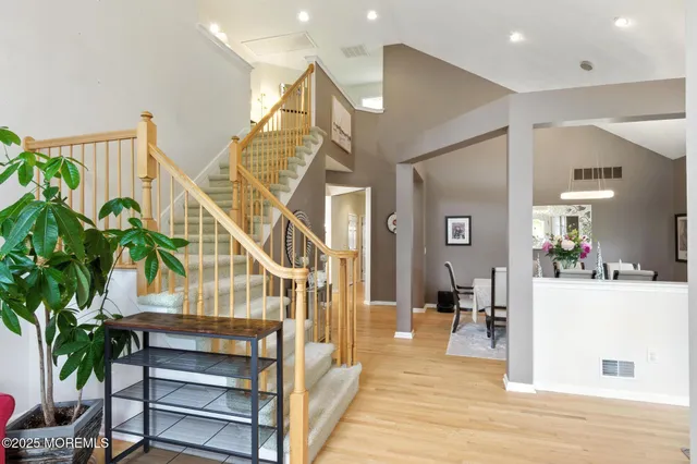 a view of entryway and hall with wooden floor