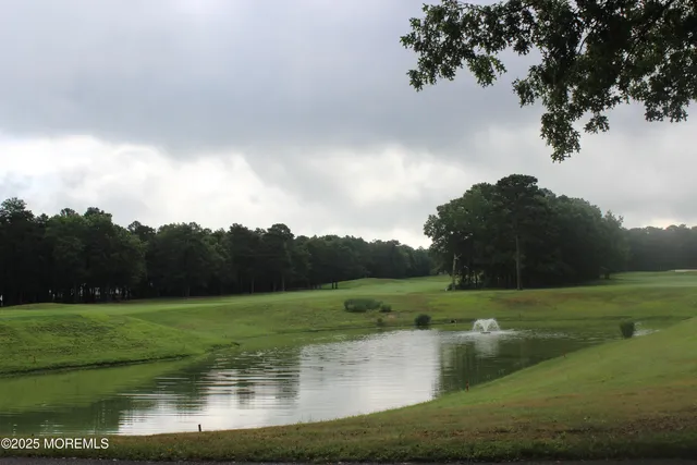 a picture of a bathroom with a white wall and a picture