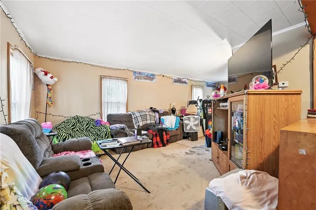 a living room filled with furniture and a large window