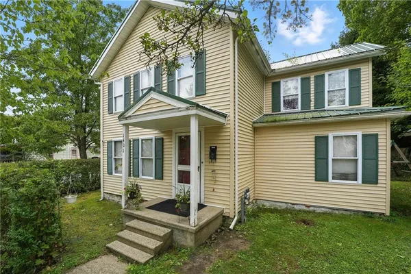 a front view of a house with a yard