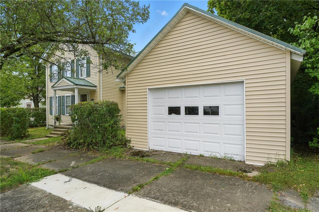 1401 Chestnut Street Franklin, PA 16323 - Photo 5 of 19 a view of a white house next to a yard and large trees