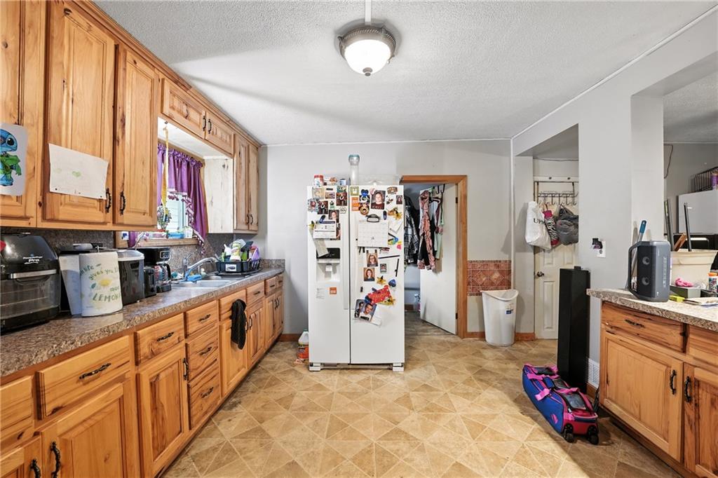 1401 Chestnut Street Franklin, PA 16323 - Photo 8 of 19 a view of a kitchen with fridge and workspace