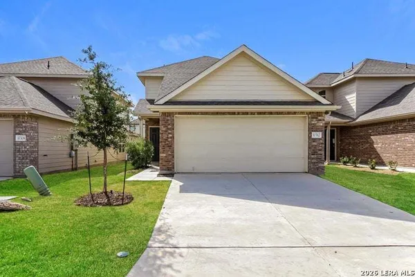 a front view of a house with a yard and garage