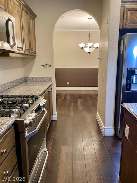 159 Tall Ruff Drive Las Vegas, NV 89148 - Photo 29 of 31 Rich hardwood flooring flows seamlessly from the functional kitchen through an elegant arched opening.