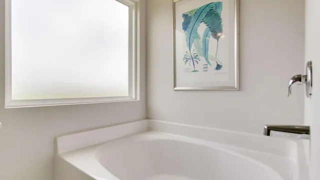 a white bath tub sitting next to a window