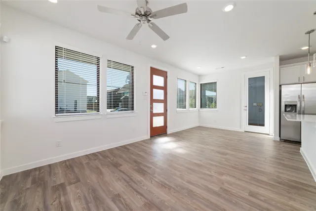 a view of a kitchen with wooden floor and electronic appliances
