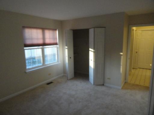 216 Homewood Drive Bolingbrook, IL 60440 - Photo 5 of 16 an empty room with windows