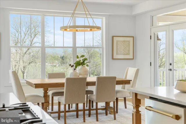 a view of a dining room with furniture a chandelier and wooden floor