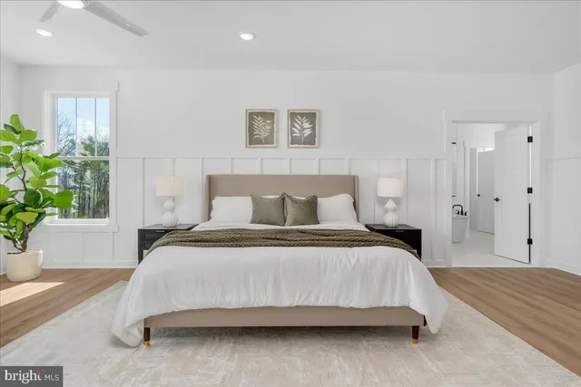 a bedroom with a bed and a potted plant