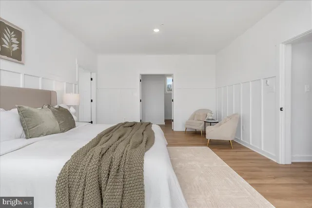 a bed room with a bed and a chair