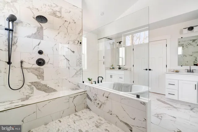 a bathroom with a double vanity sink mirror and shower