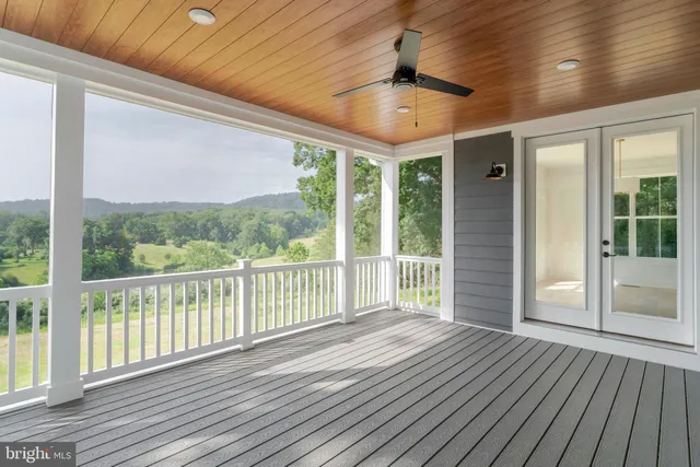 a view of a room with wooden floor and balcony
