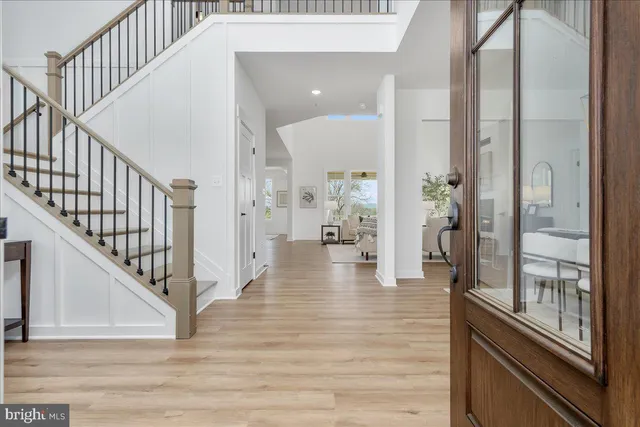 a view of a hallway view with wooden floor and staircase