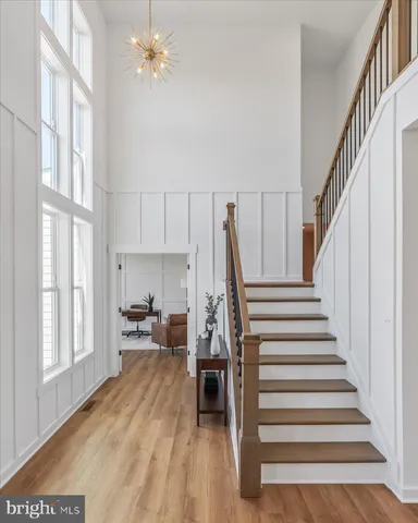 a view of entryway and hall with wooden floor