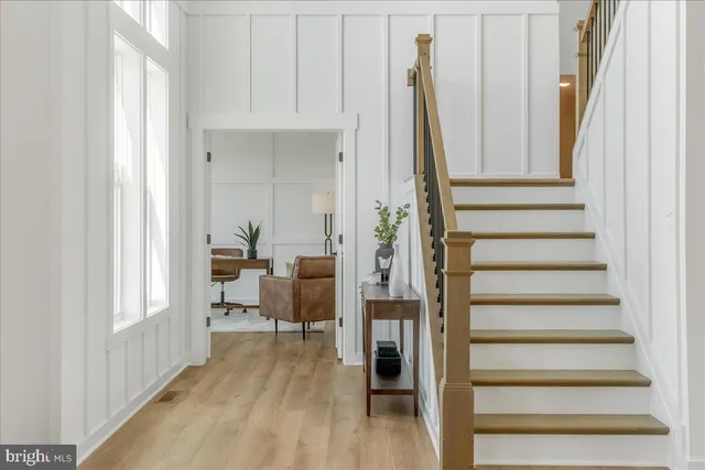a view of a room with lots of wooden furniture and windows