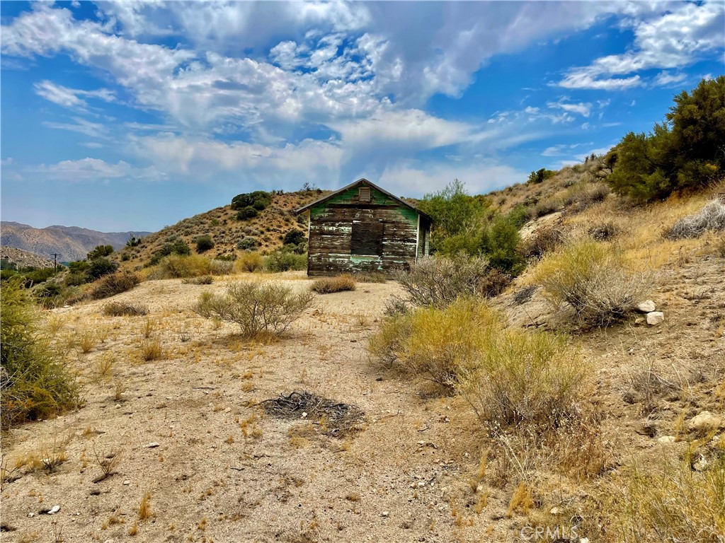 0 Pinon Avenue Morongo Valley, CA 92256 - Photo 4 of 24 a view of a dry yard with wooden fence