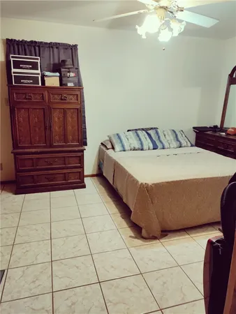 a bedroom with a bed and cabinet